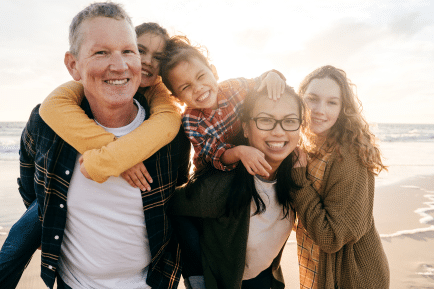 Blended family smiling at beach