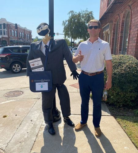 Ryan Raupe posing with scarecrow wearing Evans & Davis gear