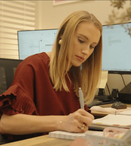 Lauren Thoman working and taking notes at desk