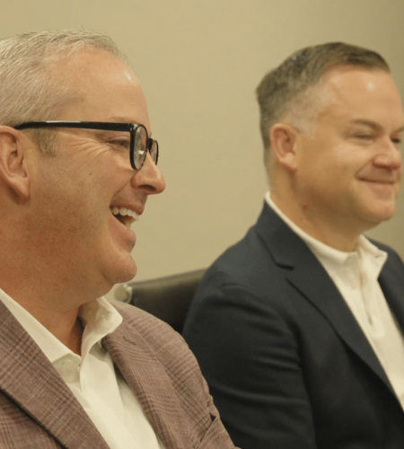 Dustin Davis smiling next to Bryan Evans